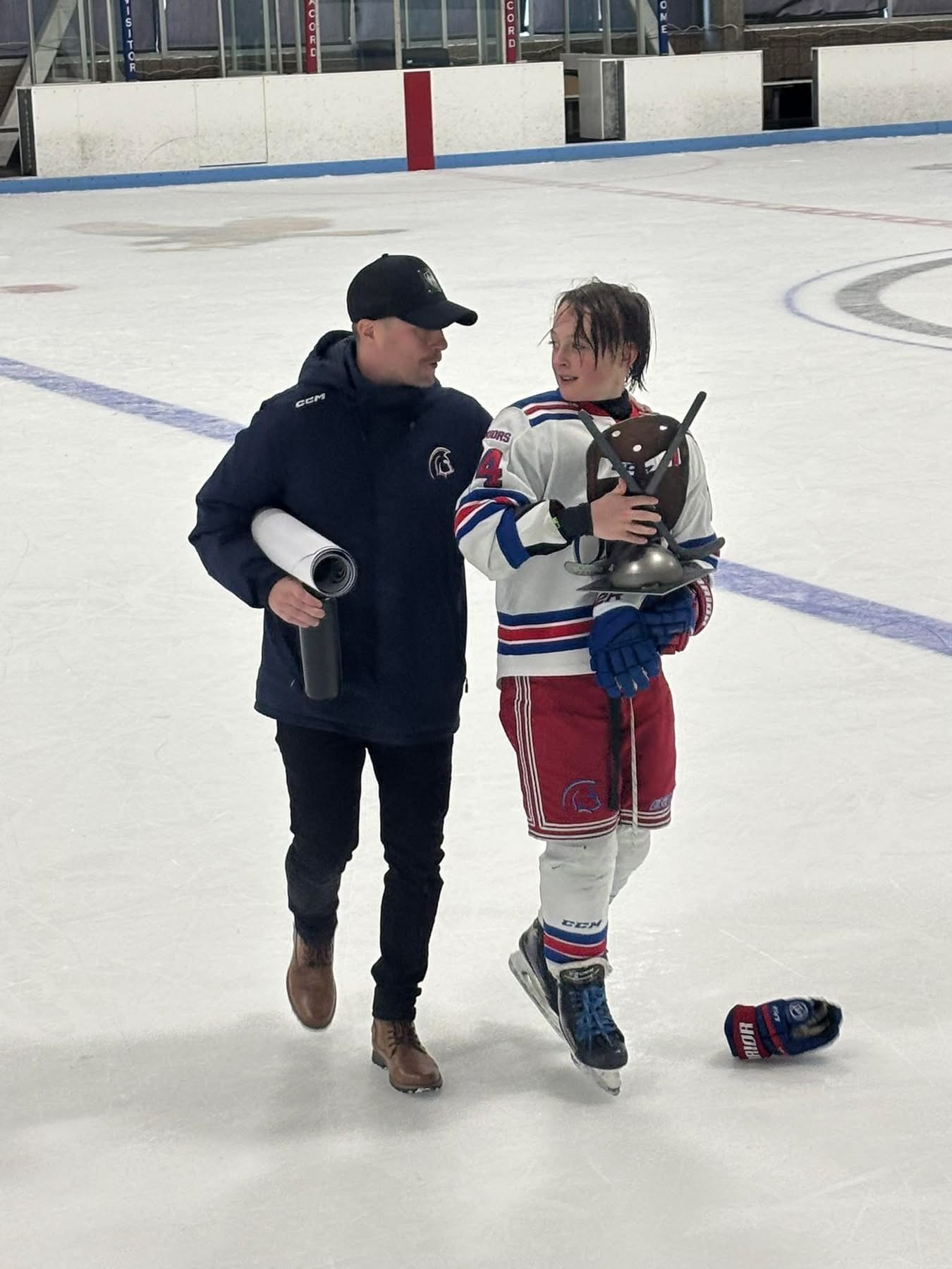 Coach Jarno Karttunen on the ice with a player
